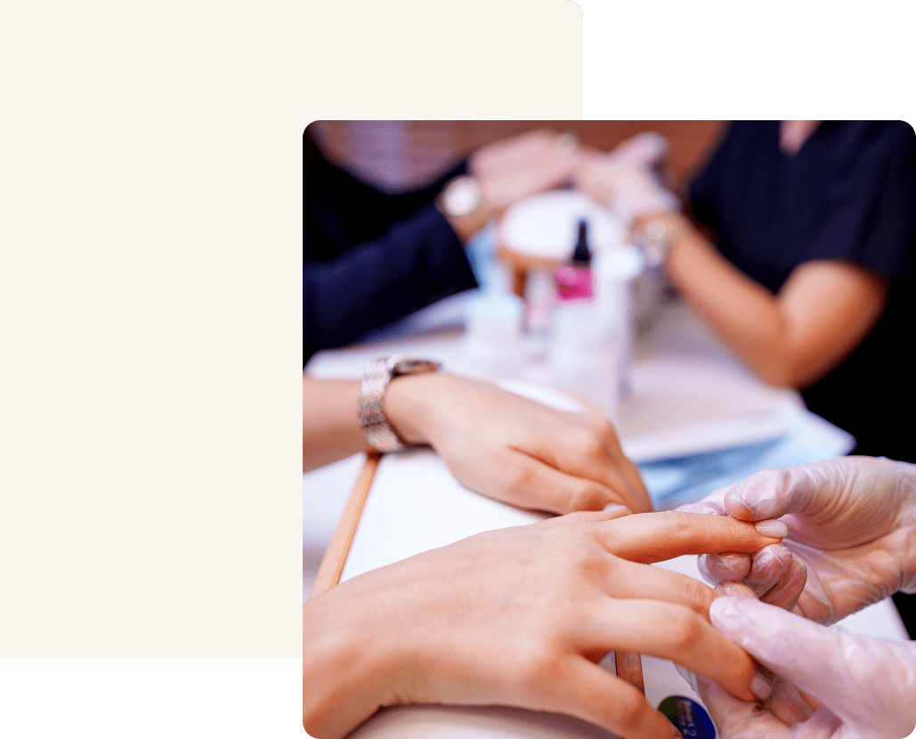 Hands receiving nail treatment